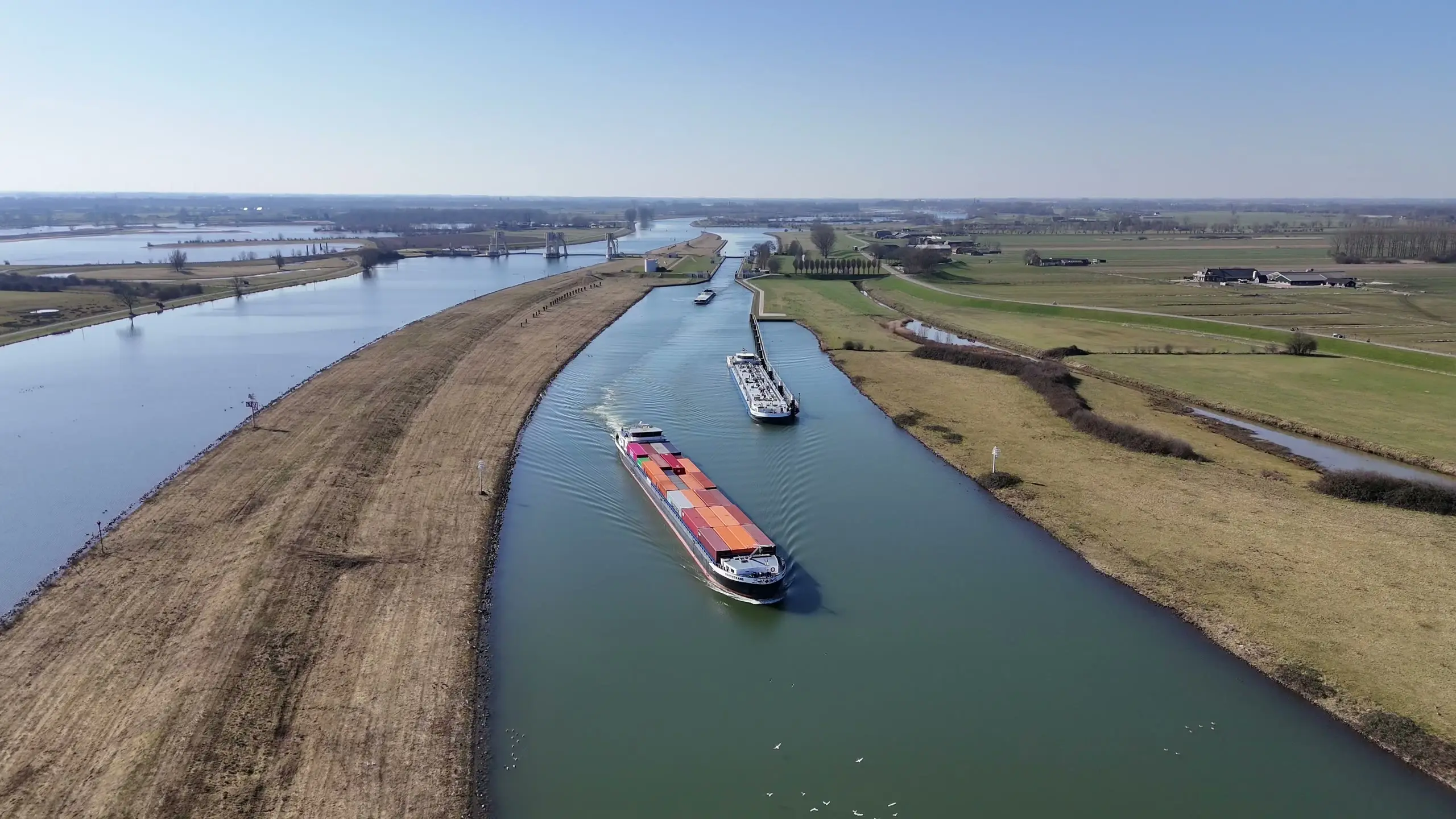 Container barge on a canal, seen from above.