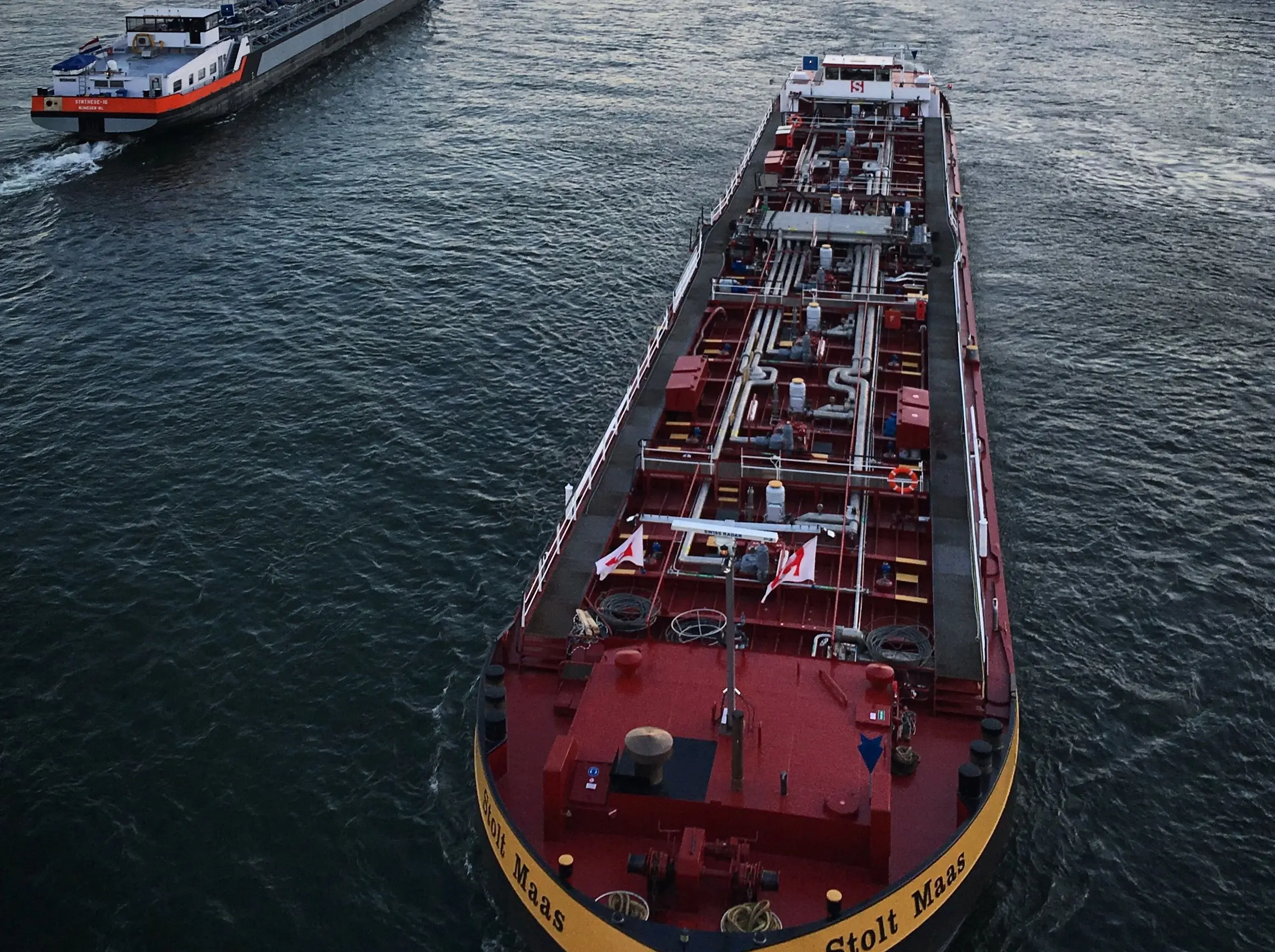Two tankers on a river, seen from a bridge.